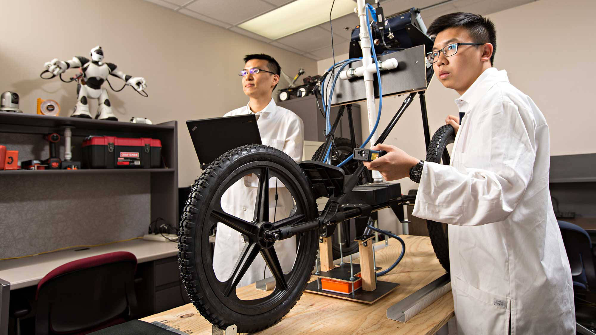 students research robot vehicle mechanics
