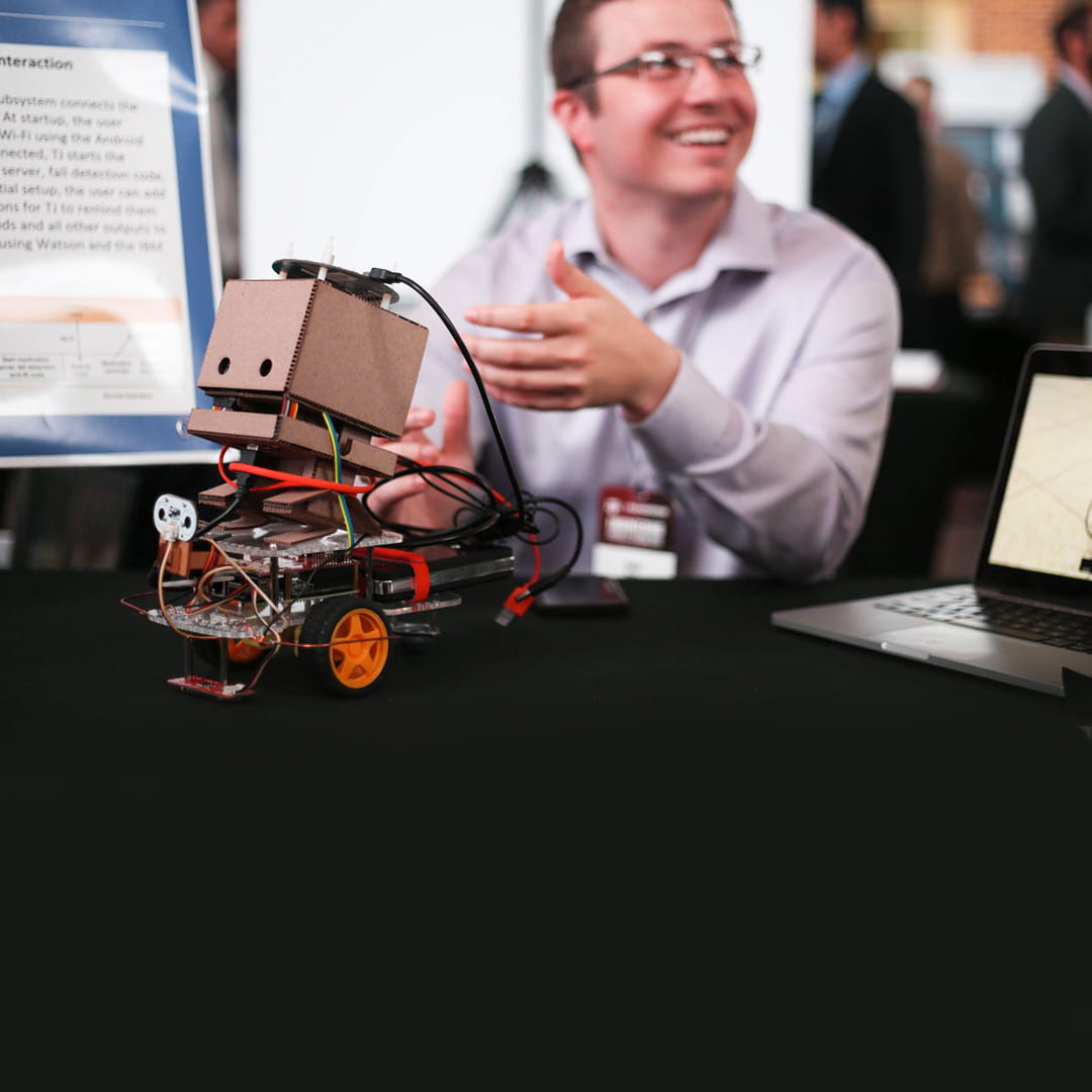 student with a robot in engineering project showcase 2018