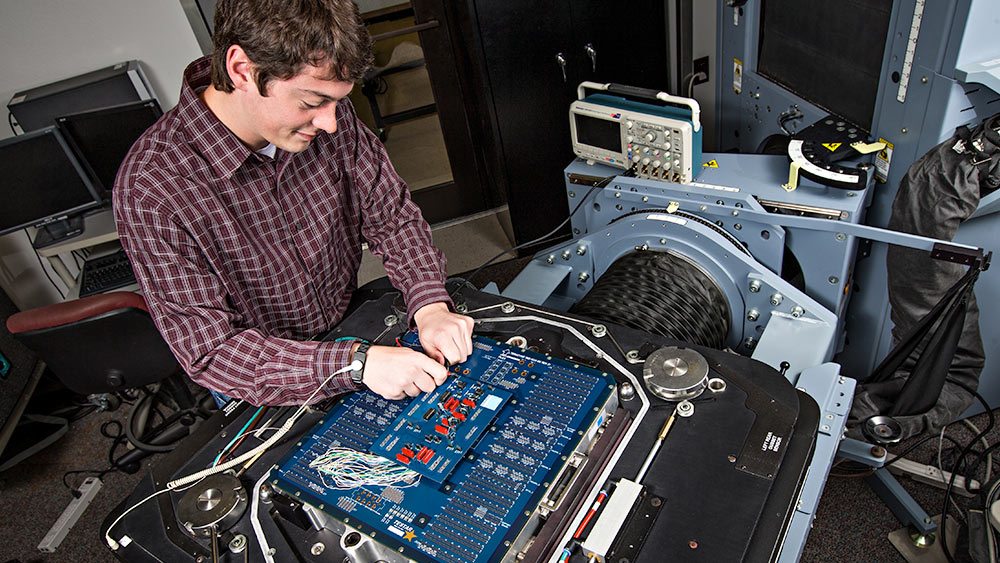 student working on electronic system equipment