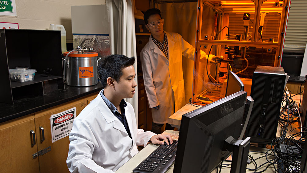 Dr. Bruce Tai and fellow researcher working in a laboratory.