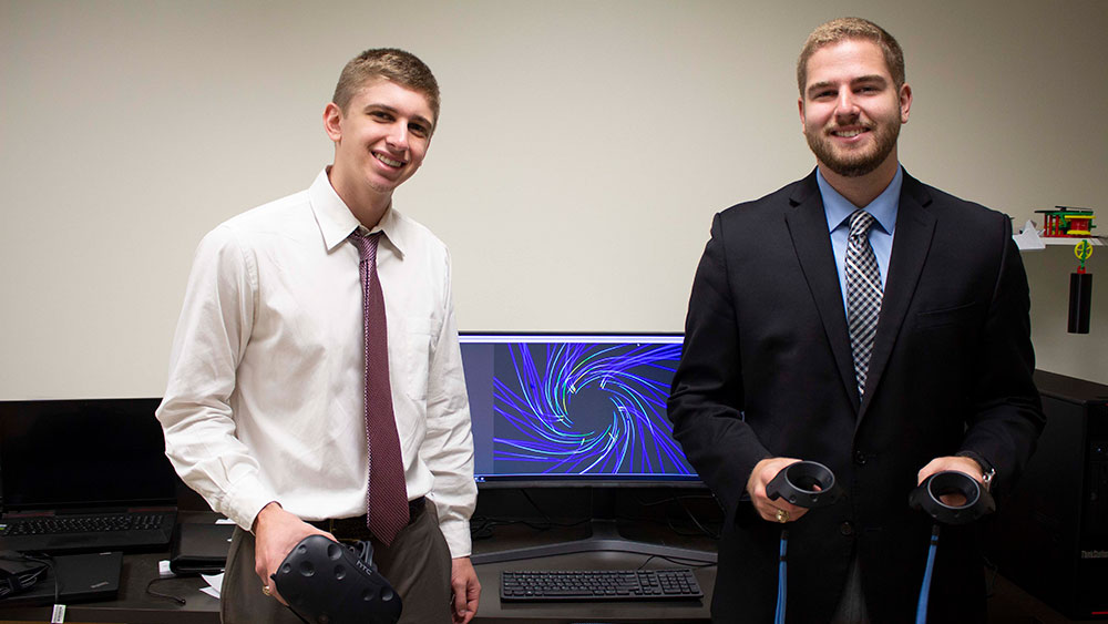 Students Justin McGinnity and Cody Piercey work alongside Texas A&amp;M Engineering IT to design VR programs for companies. 