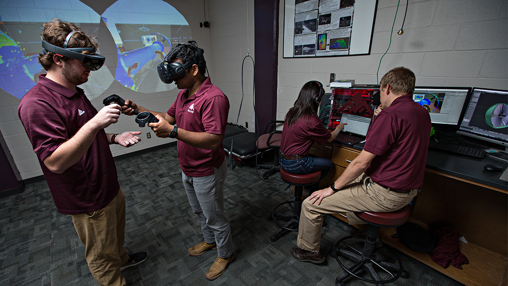 Dr. Hartl and students working in virtual reality lab