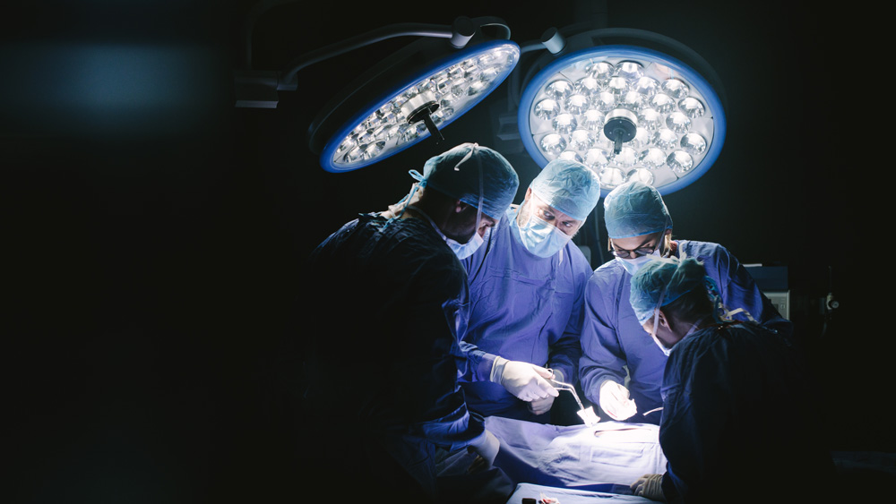 A group of surgeons around an operating table