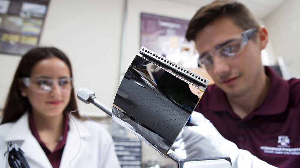 Two Texas A&M University Aerospace Engineering students working on a shape-shifting radiator in the Multifunctional Materials and Aerospace Structures Optimization (MAESTRO) Lab.