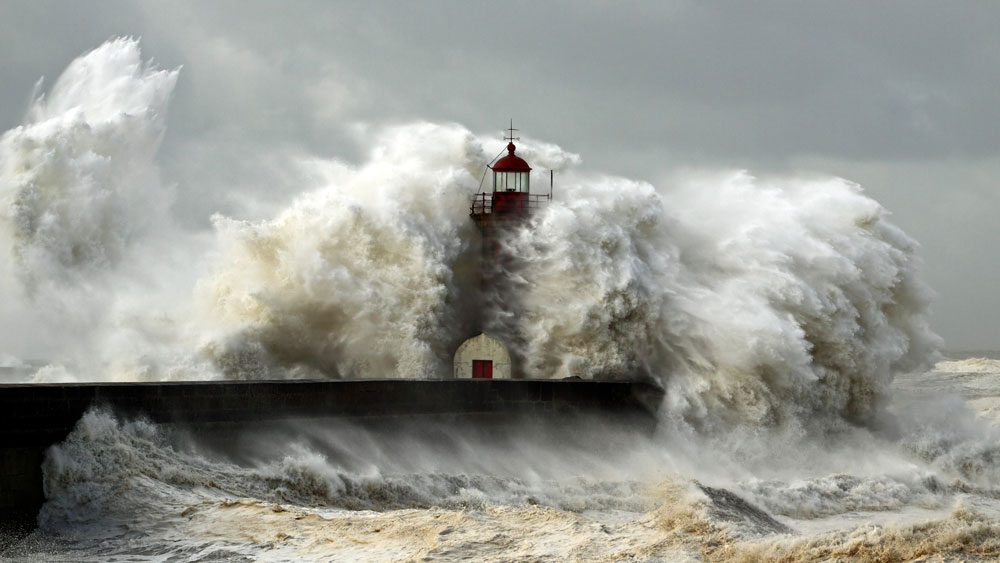 A lighthouse engulfed in a giant wave