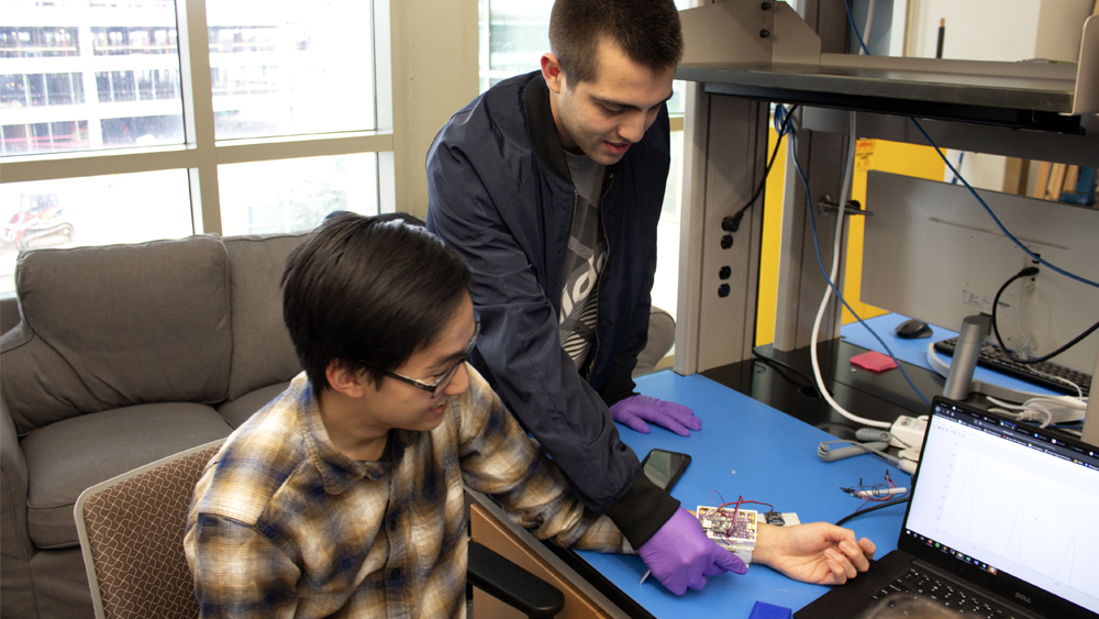 Students work with wired, prototype blood pressure cuff