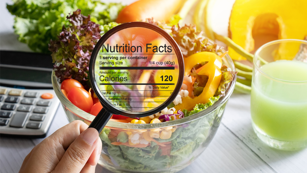 Table of food. Overlaying it is a magnifying glass looking at nutritional content