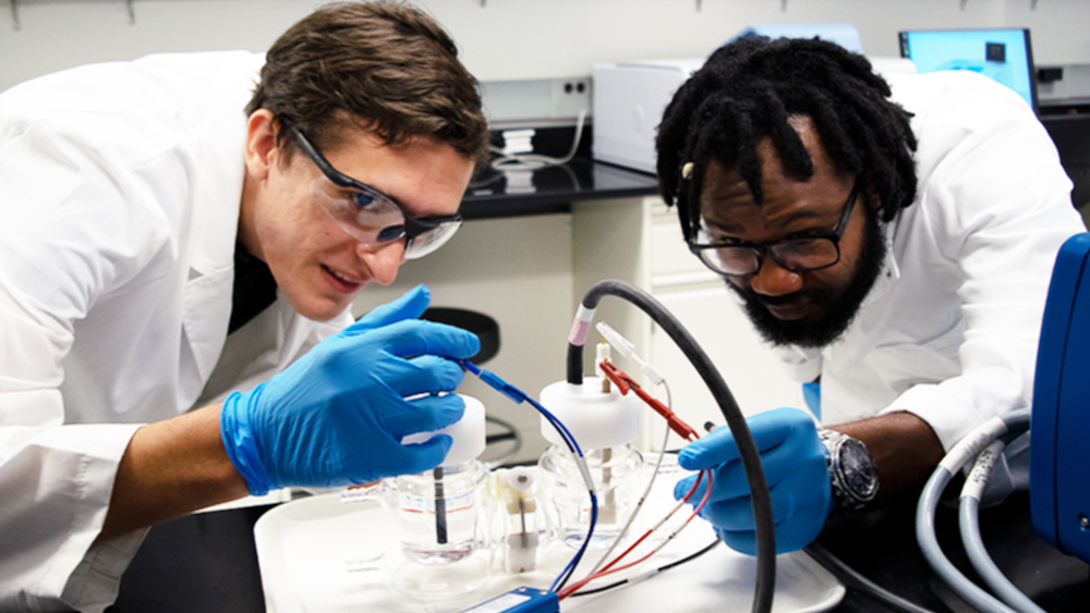 enis Johnson and Dr. Abdoulaye Djire assemble an electrochemical cell