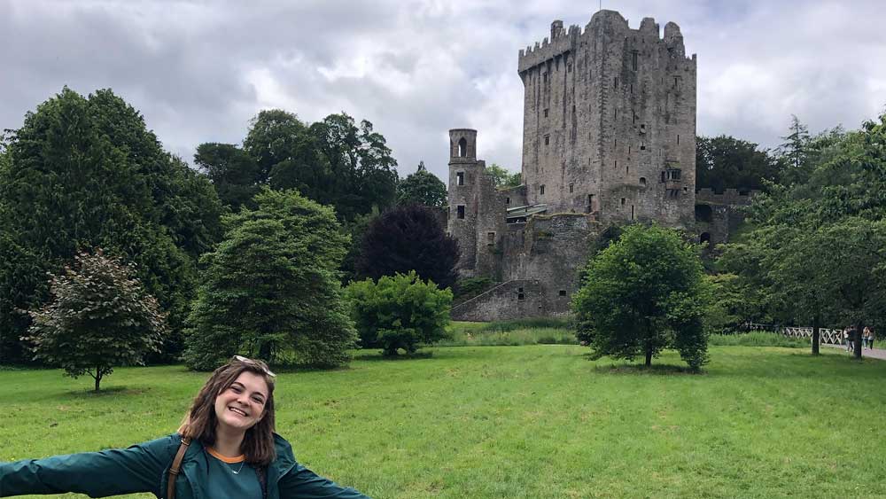 Olivia Mills stands in front of Blarney Castle in Ireland.