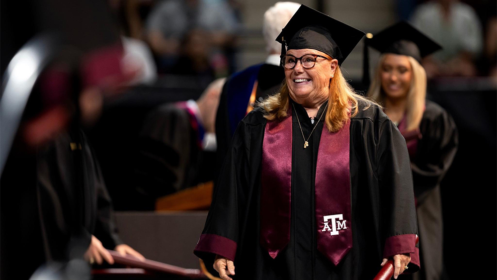 Denise Meyer wearing Texas A&M cap and gown.