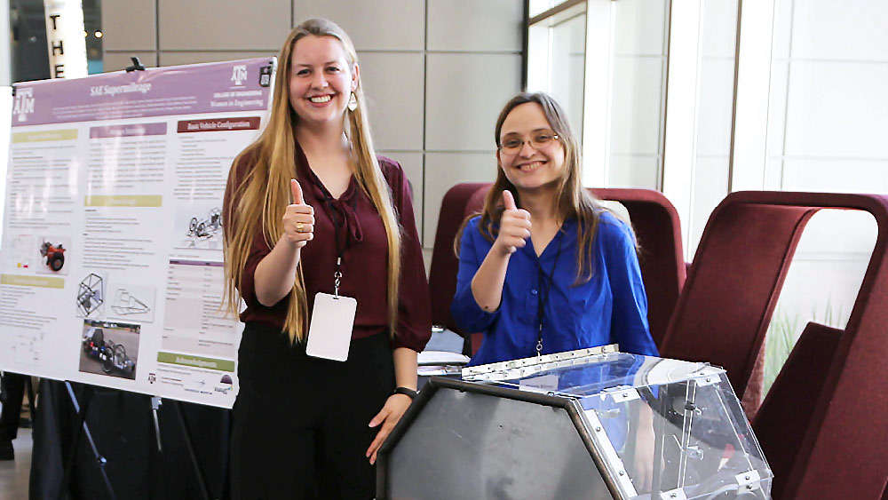 Women Aggie engineers hosting a conference booth
