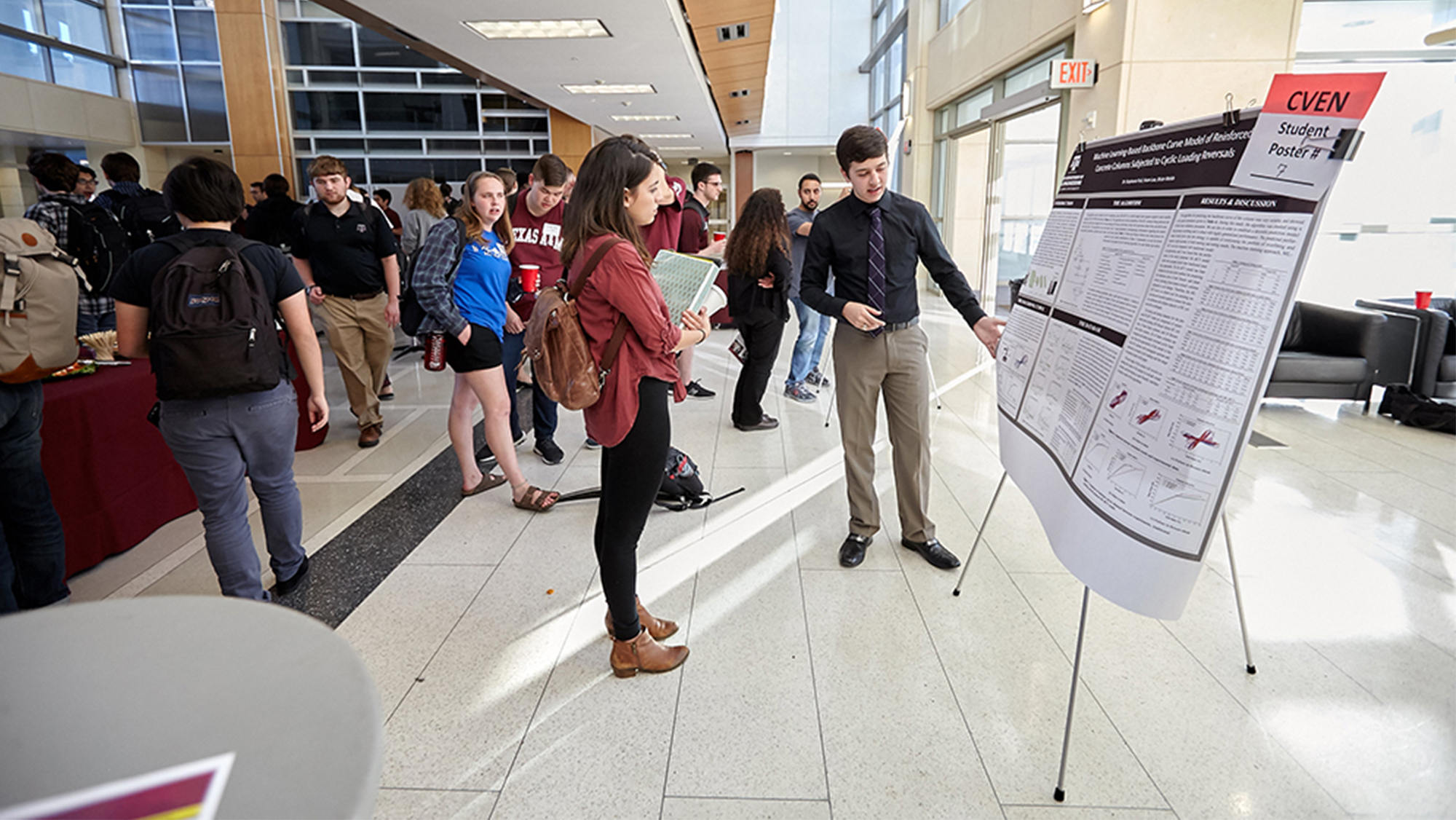 Student presents his research poster