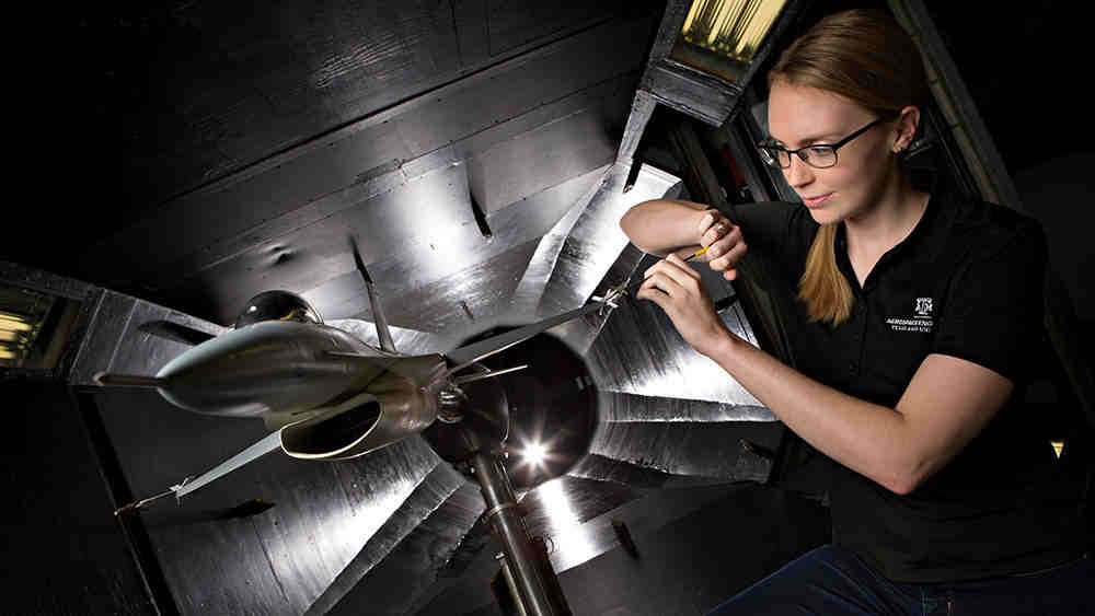 Female grad student in the low speed wind tunnel