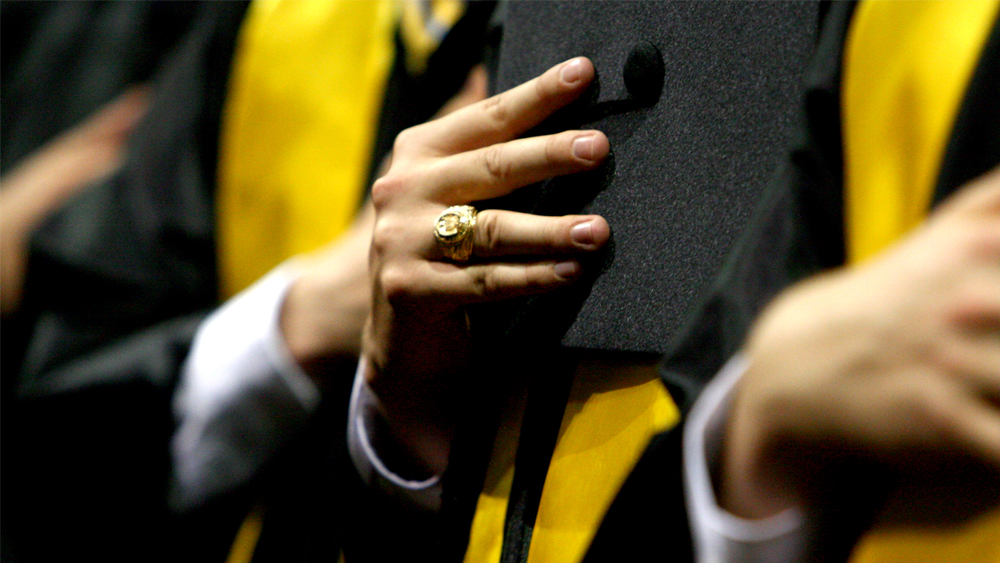 Graduation cap being held