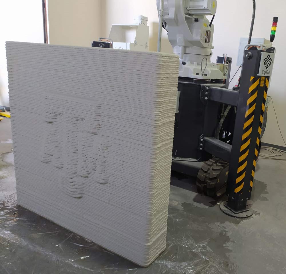 3d printed concrete structure with the Texas A&amp;M University logo printed into the side.