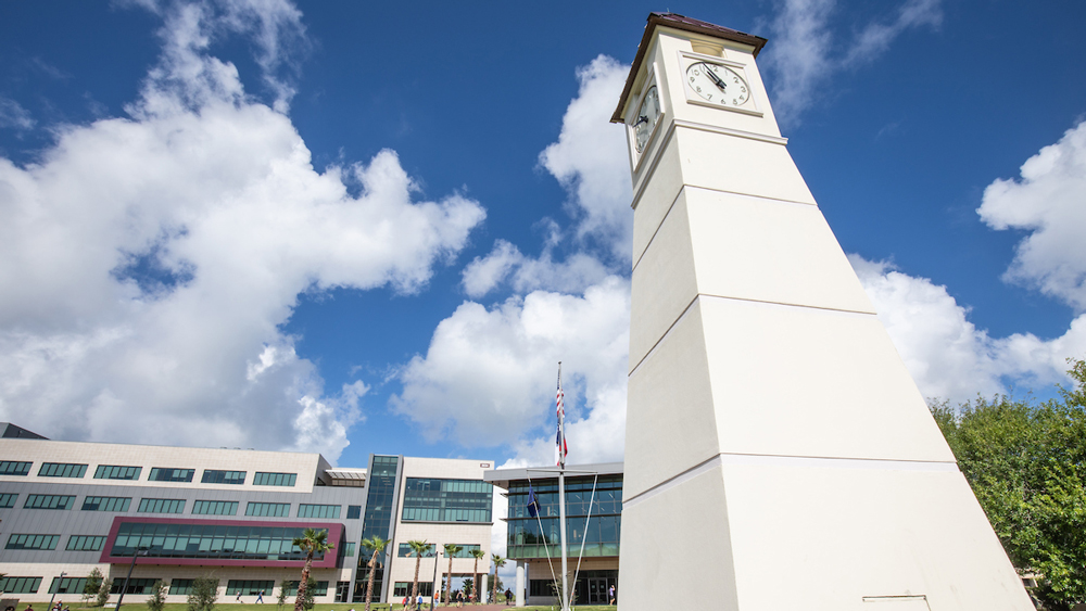 Close up of clock tower and modern building on the Galveston campus.