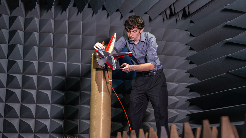 Person in a room with blue foam cones.