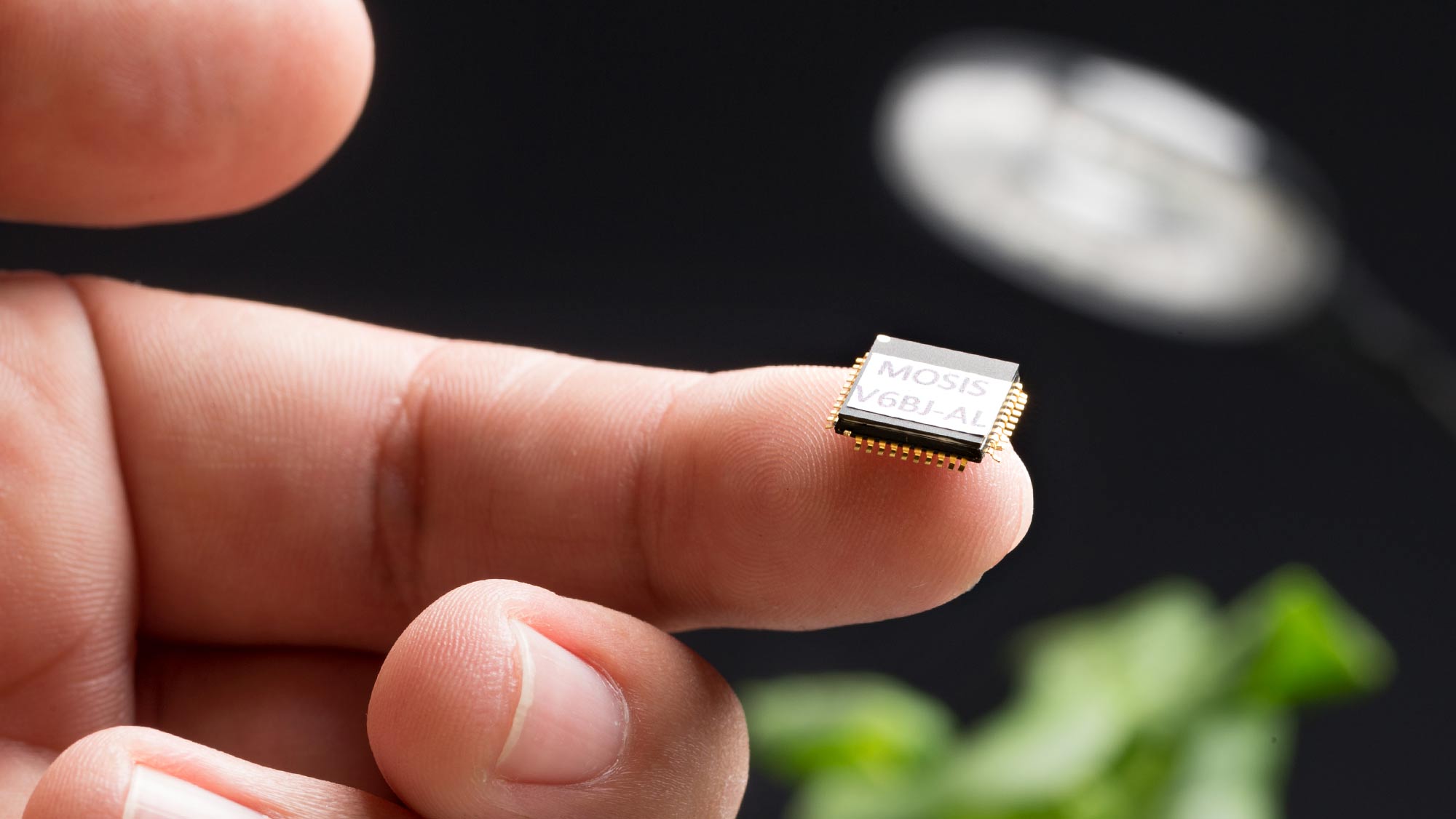 microchip on the tip of a finger