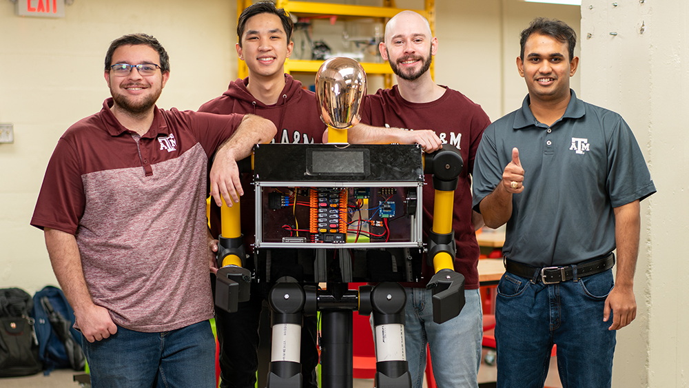 Four students standing around the robot they built