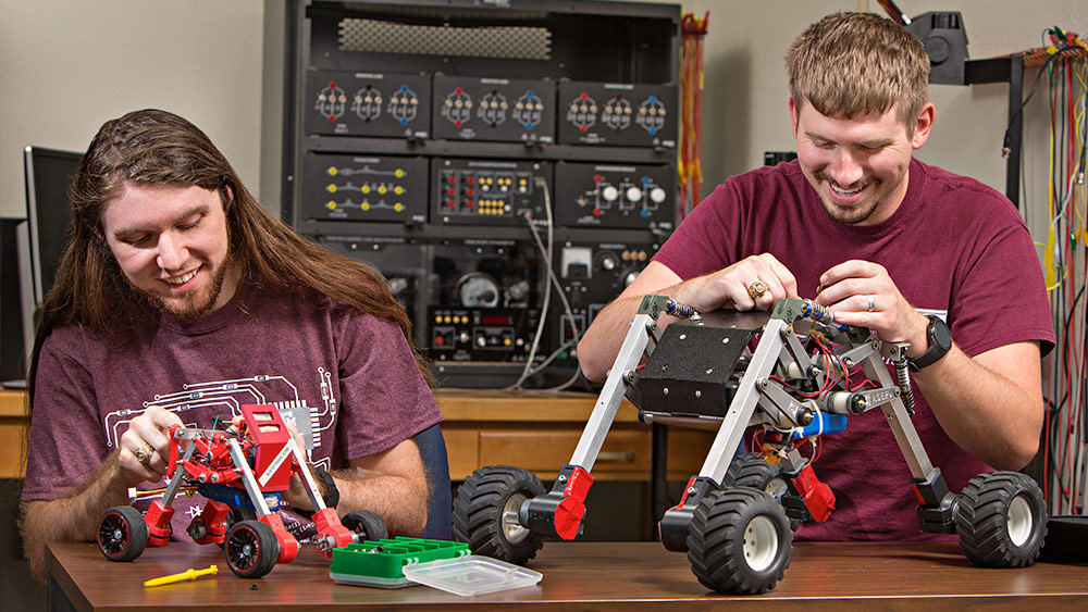 Two male students building motor vehicles.