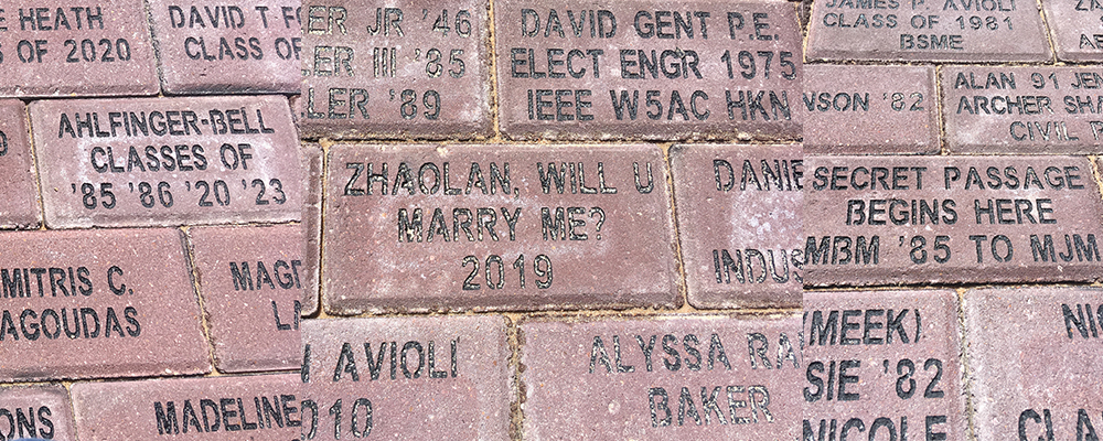 Three photos of bricks on Engineering Walk. One reads, Ahlfinger-Bell, Classes of 85, 86, 20, 23. The second reads, Zhaolan, Will U Marry Me? 2019. The last reads, Secret Passage Begins Here, MBM '85 to MJM.