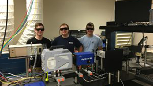 Students in a lab with protective eye gear