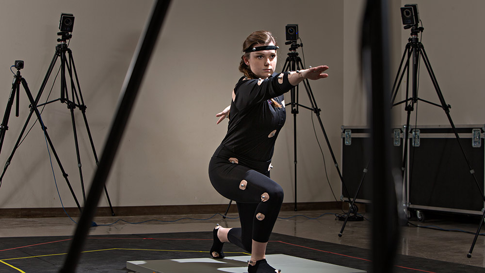 Student posing in a motion-capture lab.