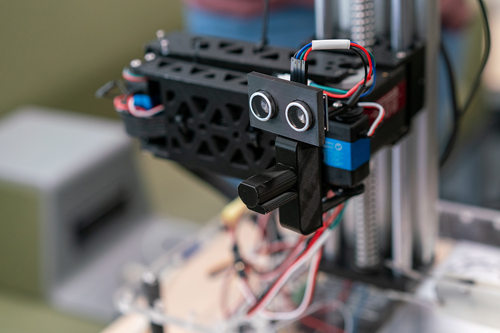 Close-up image of a capstone team's scale prototype electric vehicle charging arm. 
