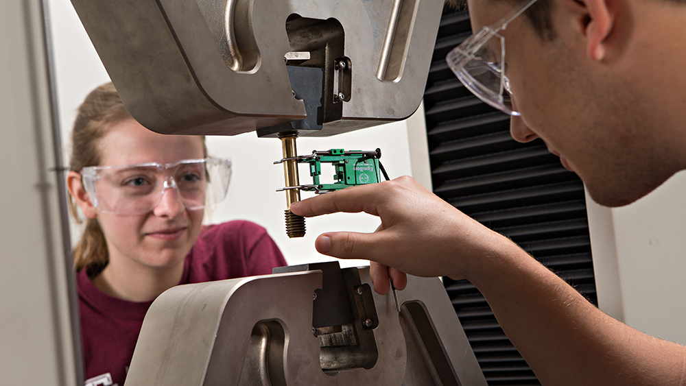 Students examining equipment in a lab