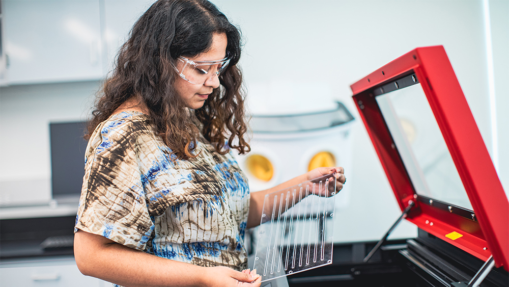 Woman in lab working on machinery 