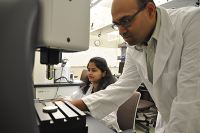 Dr. Bukkapatnam and student working in the lab