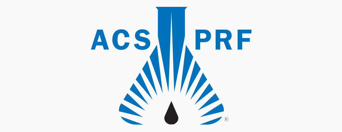 Blue and white logo for the American Chemical Society Petroleum Research Fund. It is a beaker with a black tear drop shape at the bottom with rays of while light shining from it.