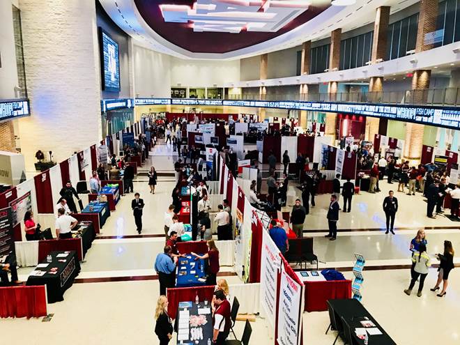 interior of hall of champions featuring tables, recruiters, and attending students