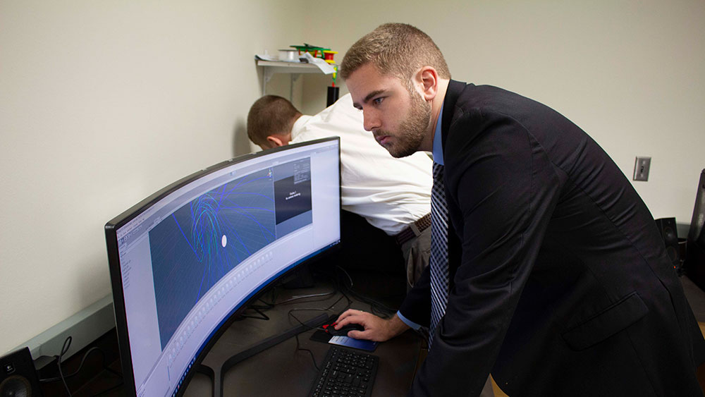 Students Justin McGinnity and Cody Piercey work alongside Texas A&amp;M Engineering IT to design VR programs for companies. 