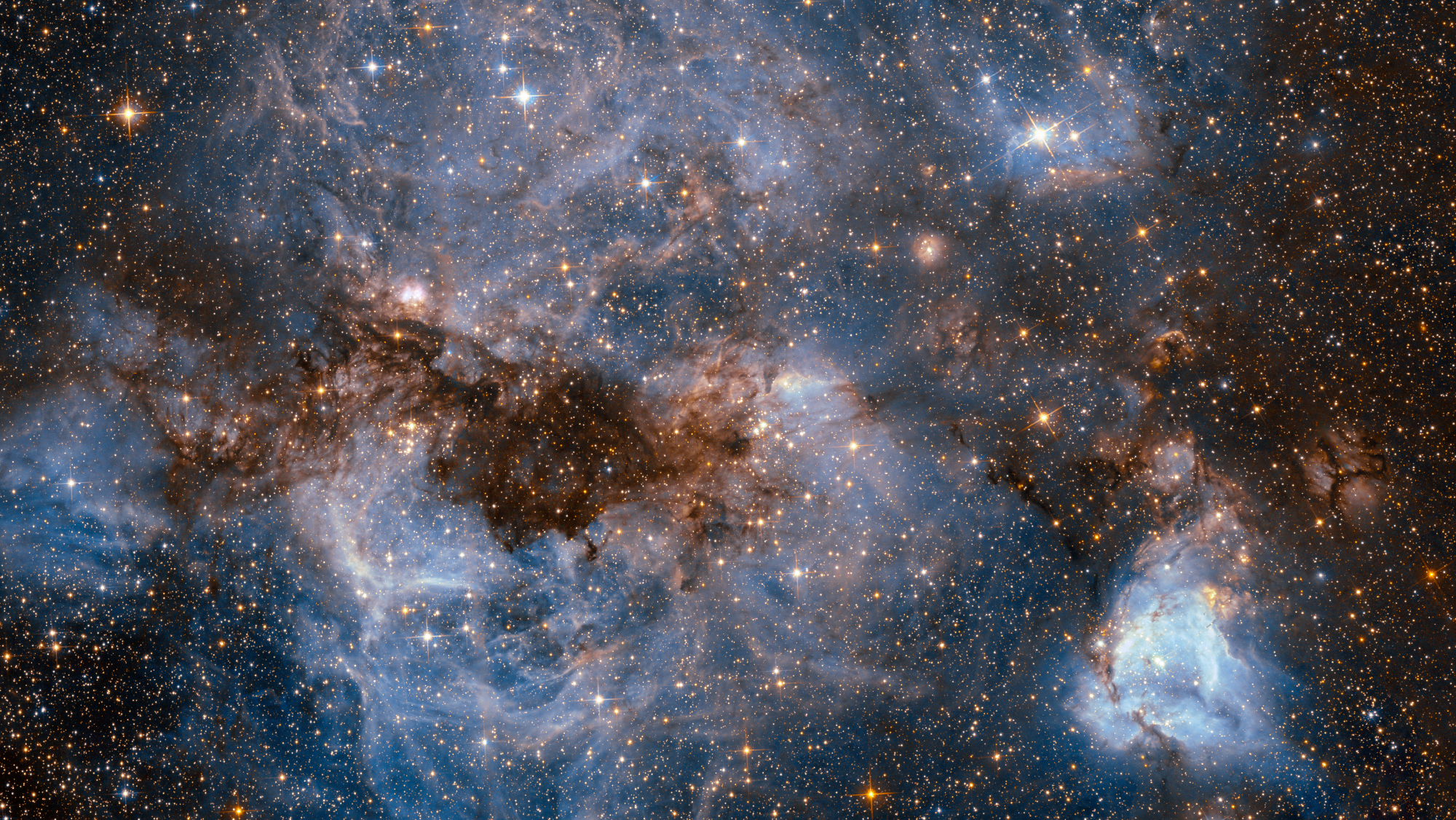 This shot from the NASA/ESA Hubble Space Telescope shows a maelstrom of glowing gas and dark dust within one of the Milky Way’s satellite galaxies, the Large Magellanic Cloud (LMC).