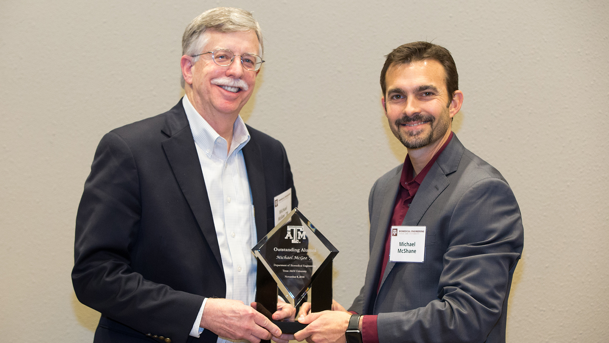 Mike McGee is presented with the crystal Biomedical Engineering Oustanding Alumni Award by Dr. Michael McShane.