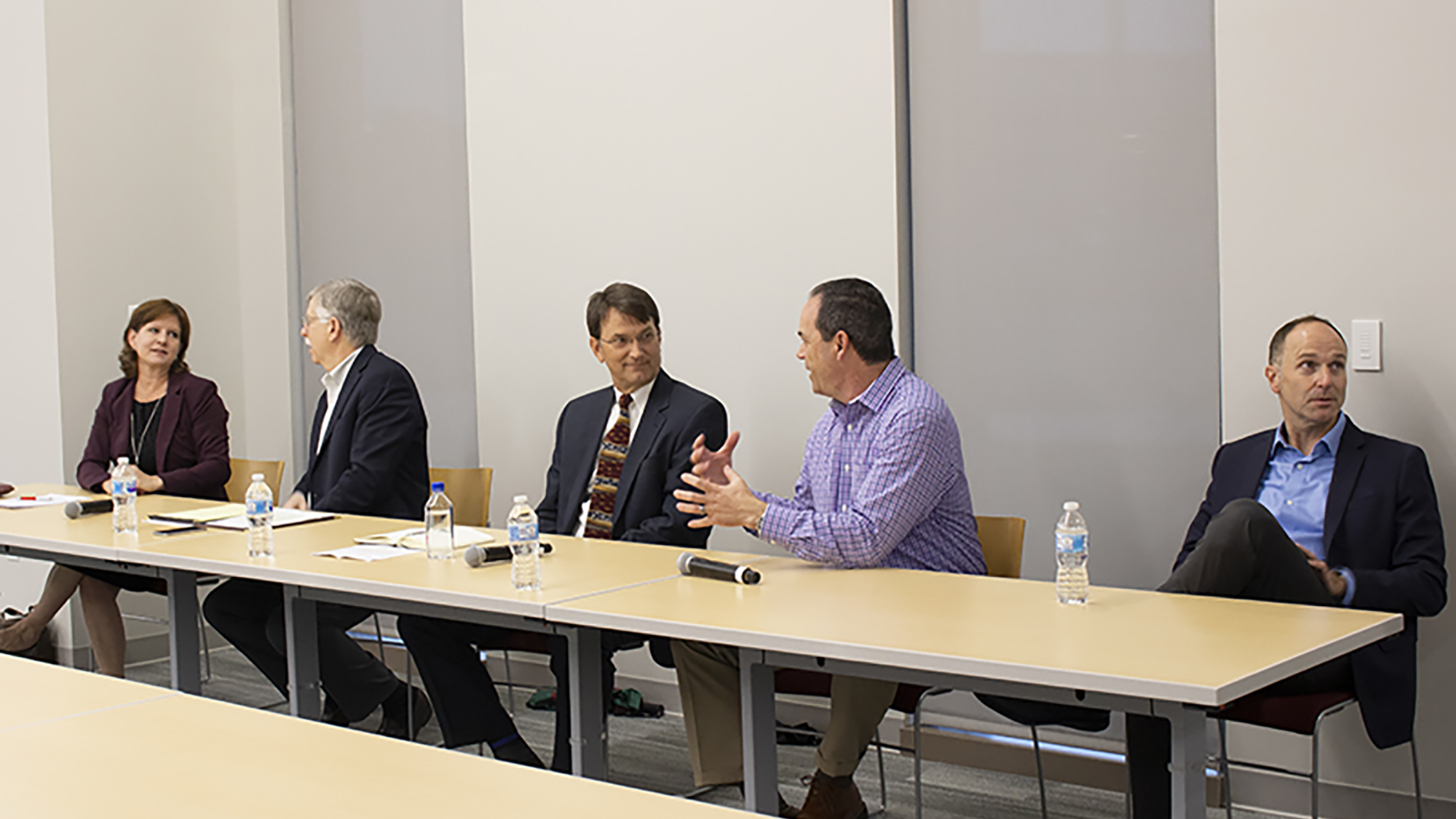 Five experts in biomedical engineering industry sit at a table in a panel format.