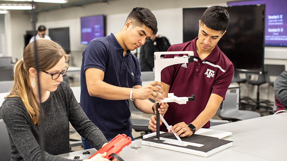 Senior mechanical engineering students work together on their capstone design project in the Fischer Engineering Design Center.
