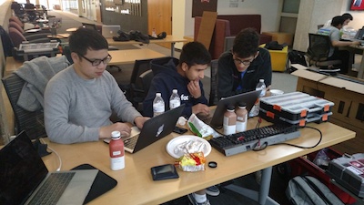 Students sitting around a computer