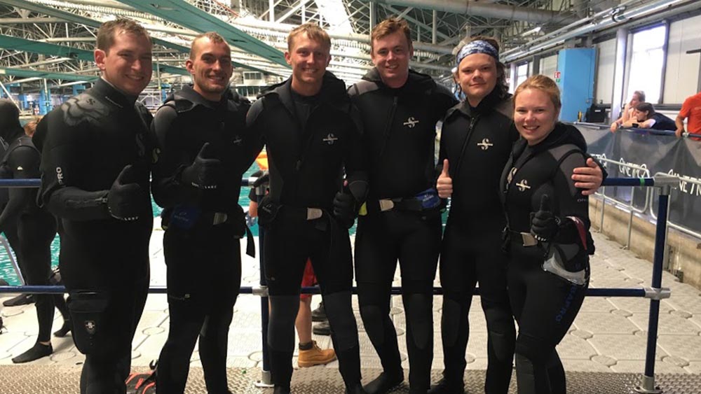 The human-powered submarine team gathers for a photo at a competition.