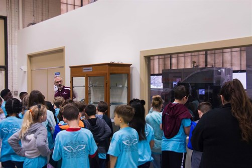 large group of fourth grade students investigate interior of industrial engineering building on Texas A&M campus