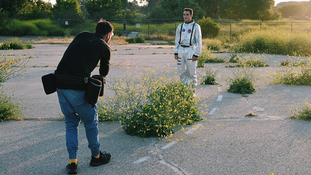 Matthew Edge in spacesuit being photographed for a book project