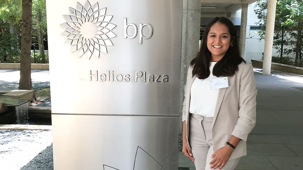 Sarah Macias smiling in front of BP Helios Plaza