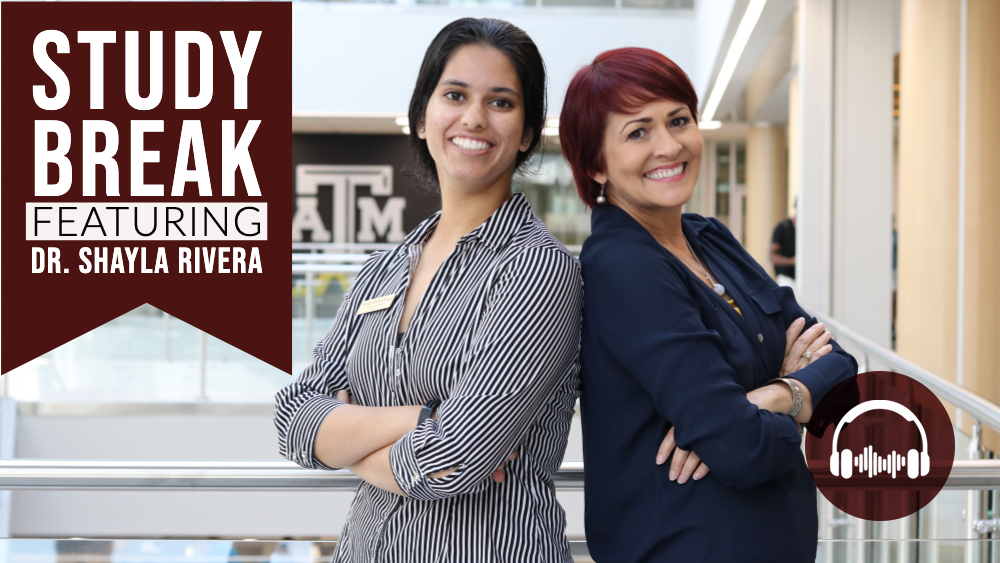 Ritika Bhattacharjee and Dr. Shayla stand with their arms folded and their backs against each other.
