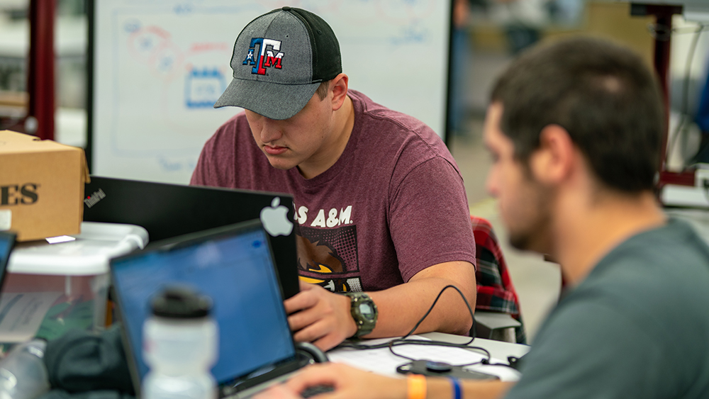 A Texas A&M University student working on his laptop during Aggies Invent: Special Operations Command.