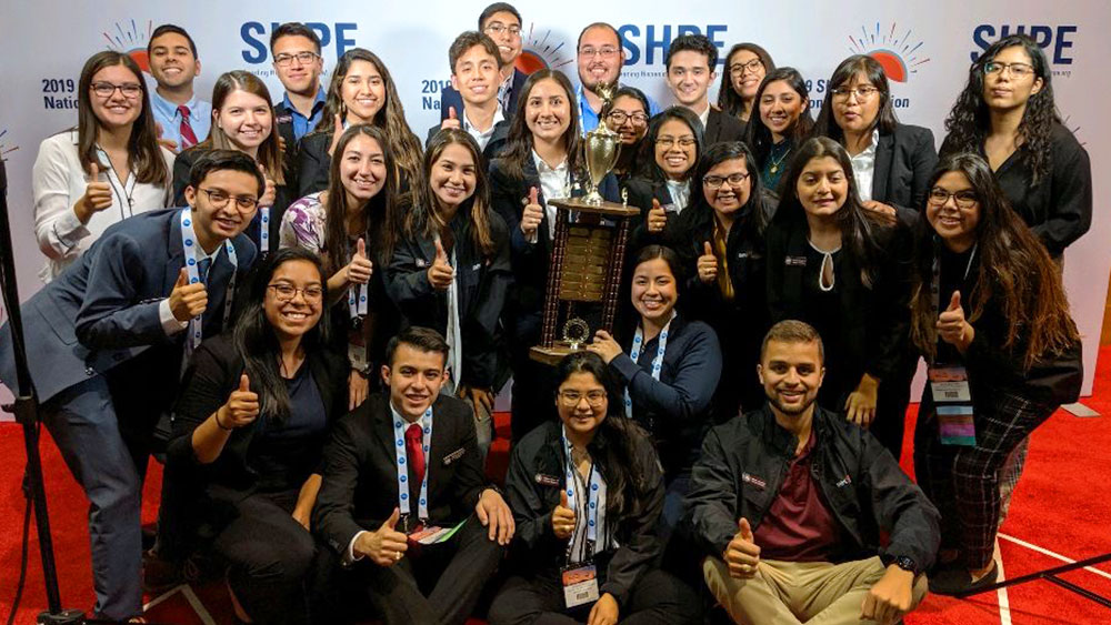 Society of Hispanic Professional Engineers organization members holding their trophy.