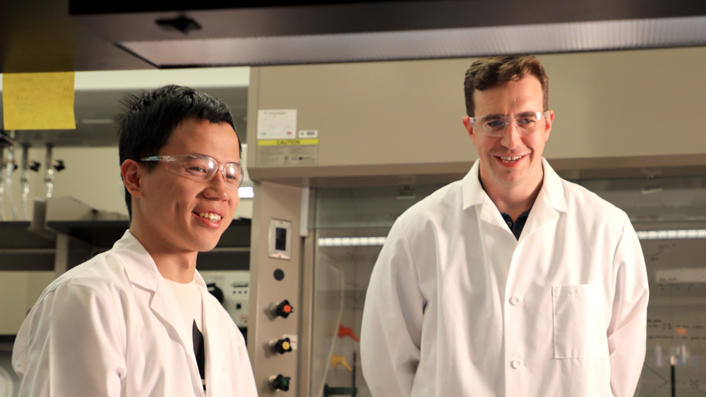 Doctoral student Shangjin Xin and Dr. Daniel Alge with lab gear smiling
