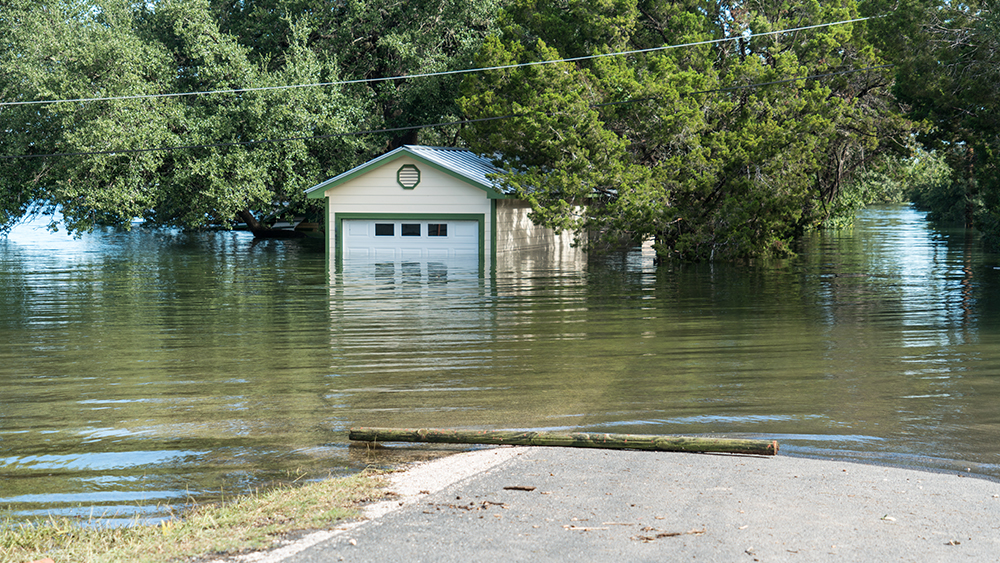 Houses, cars and streets in flood waters. 