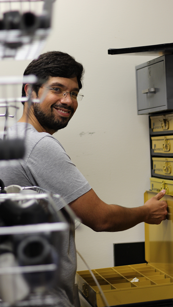 recent petroleum engineering graduate Pedro Sousa assembles parts in a workroom adjacent to the tower lab in the Richardson Building