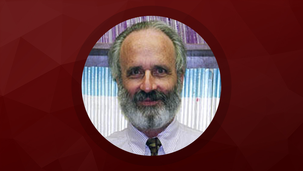Dr. William Hyman headshot with maroon background